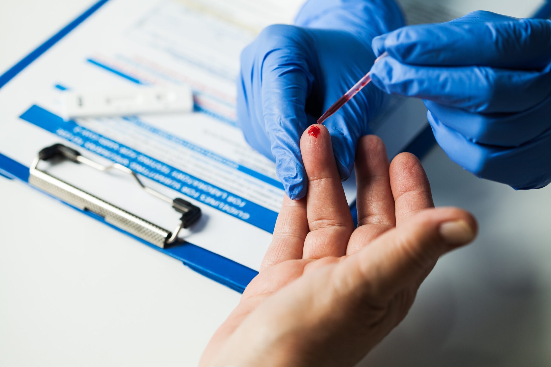 Doctor taking patient blood sample,fast serologic finger prick PRP blood antibodies lab test to determine whether person developed immunity to novel Coronavirus,global COVID-19 pandemic health crisis